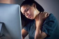 Business woman, neck pain and night in burnout, stress or fatigue by computer at office. Frustrated, overworked and Royalty Free Stock Photo