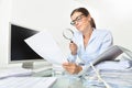 Business woman in office check documents and contracts with mag