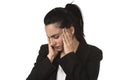 Business woman in office suit suffering migraine pain and strong headache with fingers on her tempo