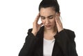 Business woman in office suit suffering migraine pain and strong headache with fingers on her tempo
