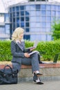 Business woman in an office suit working outside with a laptop computer. Vertical Royalty Free Stock Photo