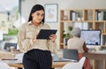 Business woman, office and working on digital tablet in the workplace with colleague in the background. Happy employee Royalty Free Stock Photo