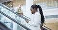 Business, woman and phone on escalator for travel, meeting or communication in office building. Black person