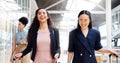 Business woman, phone and walking with luggage in travel for work trip partnership at the workplace. Happy women talking Royalty Free Stock Photo