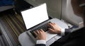 Business woman plane passenger using mock up laptop on board for working while sitting in airplane. Traveling and Royalty Free Stock Photo