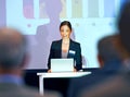 Business woman, podium and presentation with projector screen, conference or workshop with laptop for slideshow