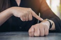 A business woman pointing at a black wristwatch on her arm in working time while waiting for someone Royalty Free Stock Photo