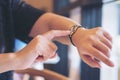 A business woman pointing at a black wristwatch on her working time Royalty Free Stock Photo