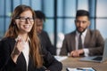 business woman pointing her finger at you while sitting at the negotiating table Royalty Free Stock Photo