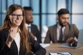 business woman pointing her finger at you while sitting at the negotiating table Royalty Free Stock Photo