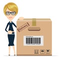 Business woman pointing to a large cardboard box. Royalty Free Stock Photo