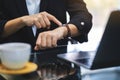 A business woman pointing at a wristwatch on her working time while waiting for someone Royalty Free Stock Photo