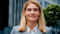 Business woman portrait close-up young happy successful caucasian businesswoman standing outdoors looking at camera Royalty Free Stock Photo