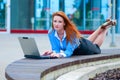 Business woman posing with a laptop in a front of office building Royalty Free Stock Photo