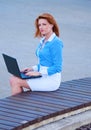 Business woman posing with a laptop in a front of office building Royalty Free Stock Photo