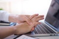 Business woman pressing the middle of her palm with her thumb to relieve pain due to a tendinitis caused by an excessive use of Royalty Free Stock Photo