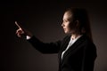 Business woman pressing virtual button over gray background Royalty Free Stock Photo