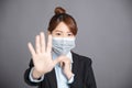 Business woman with protecting mask showing no and stop gesture
