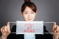 Business woman with protecting mask showing stay home and work at home concepts