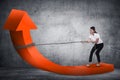 Business woman pulling arrow with chain