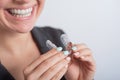 Business woman puts on transparent retainers to straighten teeth Royalty Free Stock Photo