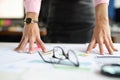 Business woman putting hands on table near glasses and documents with graphs closeup Royalty Free Stock Photo