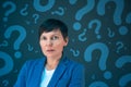 Business woman with question marks looking for answers Royalty Free Stock Photo