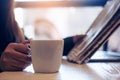 A business woman reading newspaper , holding and drinking coffee Royalty Free Stock Photo