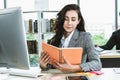 Business woman reads book at office desk Royalty Free Stock Photo