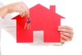 Business woman real estate agent holding red paper house keys Royalty Free Stock Photo
