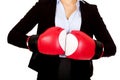 Business woman in red boxing gloves