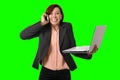 Business woman with red hair talking on the mobile cell phone holding laptop in hand isolated on green screen croma Royalty Free Stock Photo