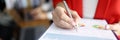 Business woman in red jacket holds clipboard with documents and pen closeup Royalty Free Stock Photo