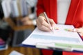 Business woman in red jacket holds clipboard with documents and pen closeup Royalty Free Stock Photo