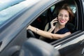 Business woman with red lips in a classic suit sitting on the driver`s seat in the car and talking on the phone Royalty Free Stock Photo