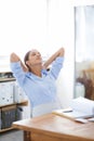 Business woman, relax and break by desk with documents for accounting, finished or finance at office. Female person Royalty Free Stock Photo