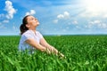 Business woman relaxing in green grass field outdoor under sun. Beautiful young girl dressed in suit resting, spring landscape, br Royalty Free Stock Photo