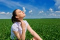 Business woman relaxing in green grass field outdoor under sun. Beautiful young girl dressed in suit resting, spring landscape, br Royalty Free Stock Photo