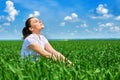 Business woman relaxing in green grass field outdoor under sun. Beautiful young girl dressed in suit resting, spring landscape, br Royalty Free Stock Photo