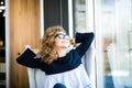 Business woman relaxing working at office desk laid back resting on chair with hands behind head with beauty smile. Royalty Free Stock Photo