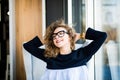 Business woman relaxing working at office desk laid back resting on chair with hands behind head with beauty smile. Royalty Free Stock Photo