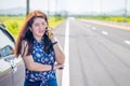 Business woman at roadside is using her mobile phone to communication with another people Royalty Free Stock Photo