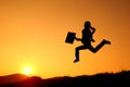 Business woman runing and sunset silhouette