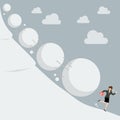 Business woman running away from snowball effect Royalty Free Stock Photo