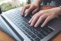 A business woman`s hands working and typing on laptop keyboard on the table Royalty Free Stock Photo