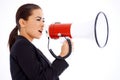 Business woman screaming loudly thru big megaphone Royalty Free Stock Photo