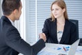 business woman shaking hands with businessman in office Royalty Free Stock Photo