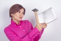 Business woman in a shirt smashes a tablet in her hands with a hammer Royalty Free Stock Photo