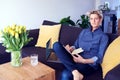 Business woman with short hair making notes, using laptop at modern apartment. Concept of young entrepreneur works on start-up