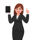 Business woman showing or holding a brand new digital tablet computer and gesturing or pointing index finger up. Female character. Royalty Free Stock Photo